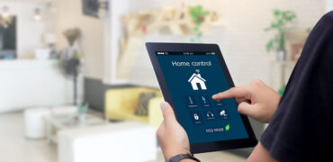 Blog-Image: A person looking at a real estate related picture in his tablet.